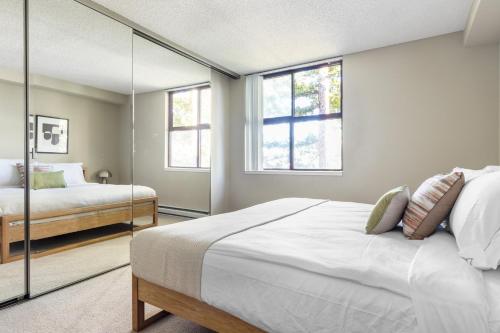 a bedroom with a large bed and a mirror at Cupertino 2BR w Gym Pool nr Apple Google SFO-310 in Cupertino