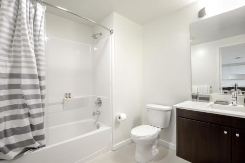 a bathroom with a toilet and a sink and a shower at SoMa 1BR w WD Gym Roofdeck nr Muni BART SFO-273 in San Francisco