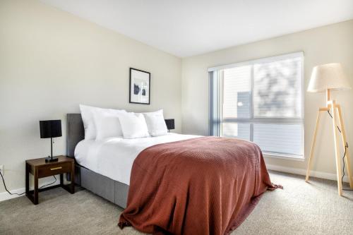 a bedroom with a large bed and a window at Santa Clara 2BR w Parking Gym nr Groceries SFO-446 in Santa Clara