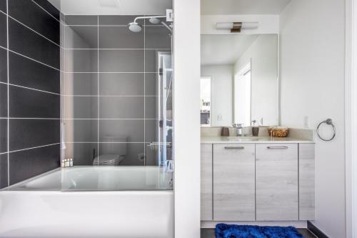 a white bathroom with a tub and a sink at SoMa 1BR w WD Rooftop nr BART Muni SFO-461 in San Francisco