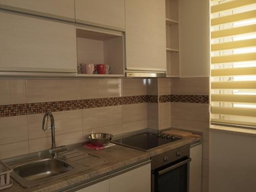 a kitchen with a sink and a counter top at Apartments Lavanda in Budva