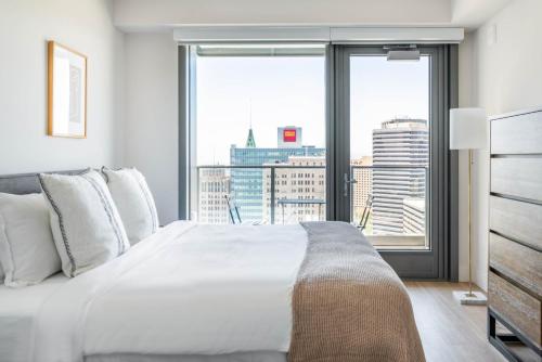 - une chambre avec un grand lit blanc et une grande fenêtre dans l'établissement Oakland 2BR w AC WD Sky Deck next to BART SFO-528, à Oakland