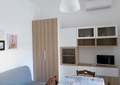 a bedroom with a bed and a tv and cabinets at Villa Marisole in Torre Canne