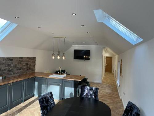 a kitchen with a table and chairs and a counter at West Loch Farm Bothy in Peebles