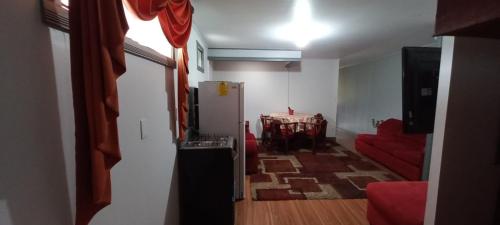 uma sala de estar com um frigorífico e um sofá vermelho em Casa Dota em Santa María