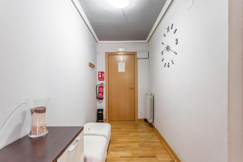 a room with a hallway with a door and a table at hospedaje Miluce in Pamplona