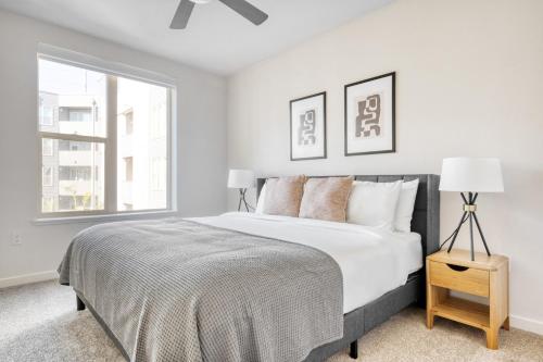 a white bedroom with a large bed and a window at Milpitas 2BR w Pool Gym Lounge nr BART SFO-822 in Milpitas