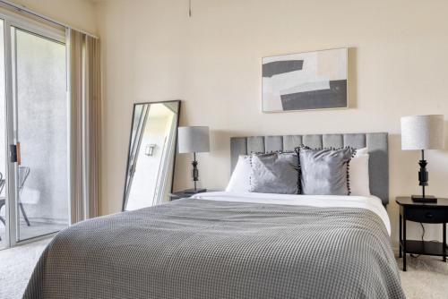 a bedroom with a large bed and a mirror at Fremont 2BR w Pool WD Gym nr TJ WF SFO-964 in Fremont