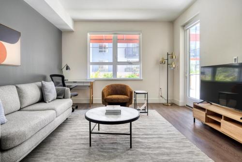 a living room with a couch and a tv at San Mateo 1BR w Gym Roof WD nr Caltrain SFO-1044 in San Mateo