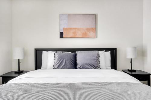 a bedroom with a large bed with two lamps at San Mateo 1BR w Gym Roof WD nr Caltrain SFO-1044 in San Mateo