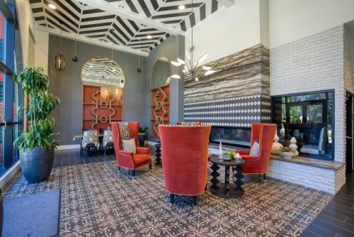 a lobby with red chairs and a fireplace at San Mateo 1BR w Gym Roof WD nr Caltrain SFO-1044 in San Mateo