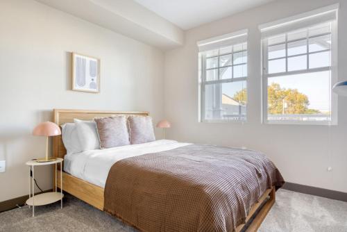 a white bedroom with a bed and two windows at Burlingame 1BR w gym wd rooftop nr Caltrain SFO-1056 in Burlingame