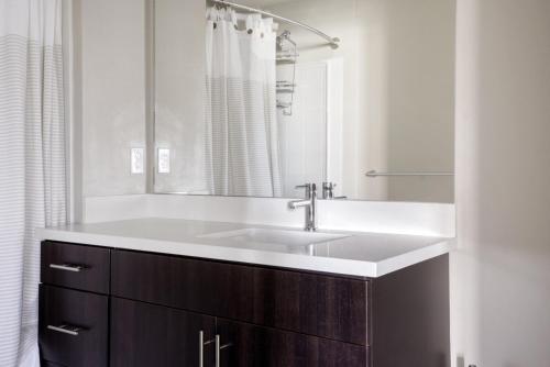 a bathroom with a sink and a mirror at Burlingame 1BR w gym wd rooftop nr Caltrain SFO-1056 in Burlingame
