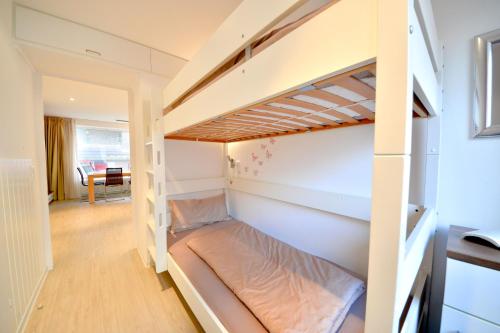 a small room with a bunk bed in it at Haus Poseidon - Wohnung 1 1 in Wangerooge