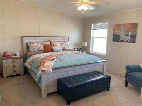 a bedroom with a bed with a ottoman in it at Amazing Views near Grand Canyon Skywalk in Meadview