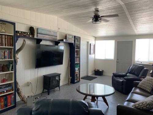 a living room with a couch and a tv and a table at Amazing Views near Grand Canyon Skywalk in Meadview