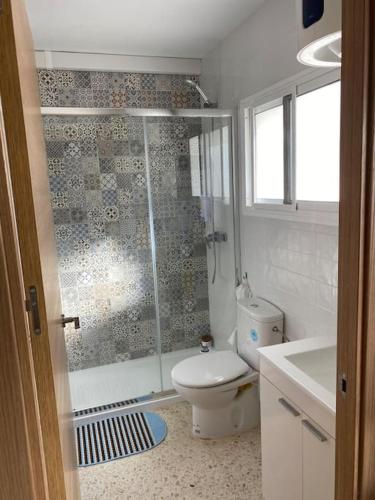 a bathroom with a shower and a toilet and a sink at Ático en Barbate in Barbate