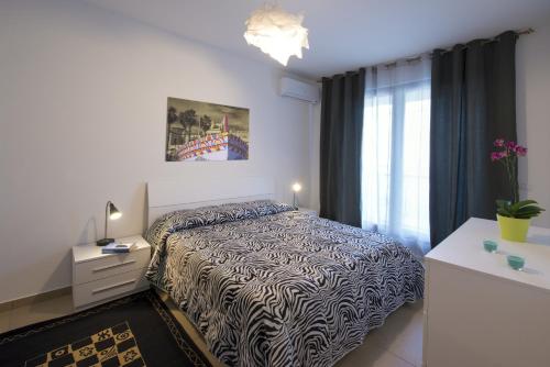 a bedroom with a bed and a dresser and a window at Residence Rapisardi by RECEPTIO in Catania