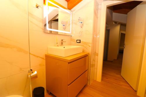 a bathroom with a sink and a mirror at Fegi Rooms in Himare