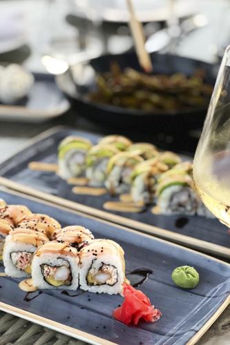 two trays of sushi with a glass of wine at Playa Palmera Beach Resort in Punta Cana