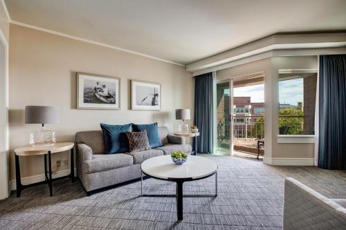 a living room with a couch and a table at The Woodmark Hotel & Still Spa on Lake Washington in Kirkland