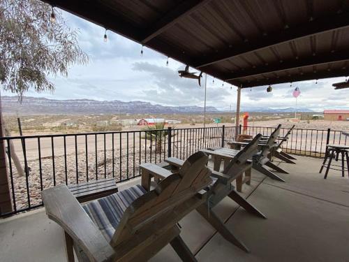 a group of picnic tables and chairs on a porch at Amazing Views near Grand Canyon Skywalk in Meadview