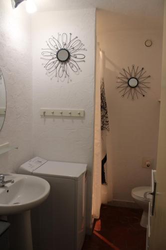 a bathroom with a sink and a toilet and a mirror at Appartement entier 40m2 in Les Arcs sur Argens