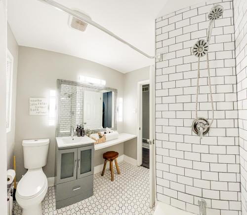 a white bathroom with a toilet and a sink at Retreat with Sauna Near ATL Large Backyard with Deck in Tucker