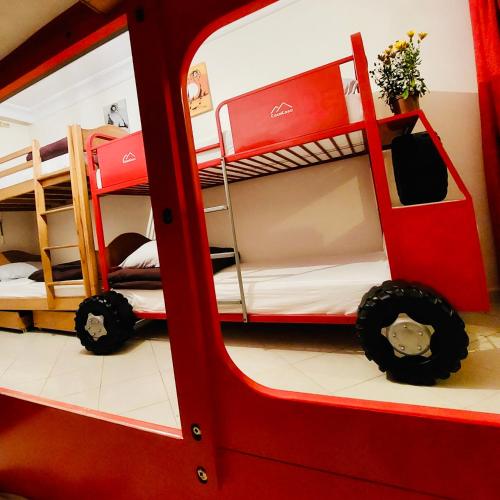 a room with two bunk beds and a red bus at CocaCosa in Casablanca