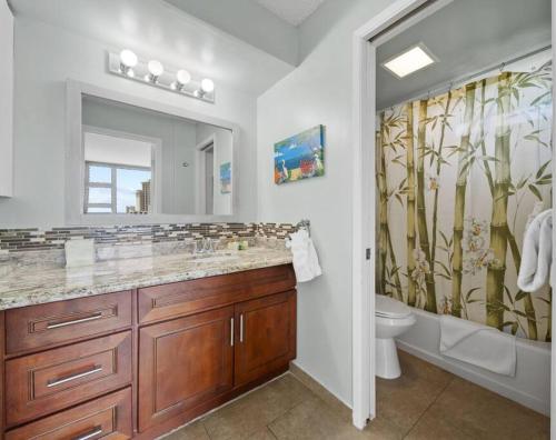 a bathroom with a sink and a toilet and a shower at Hoʻomaha 1 bedroom Suite + 1 Free Parking in Honolulu