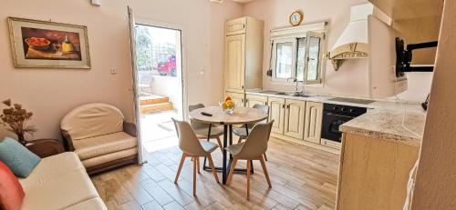 a kitchen with a table and chairs in a room at Seaside Serenity Kefalos in Kefalos