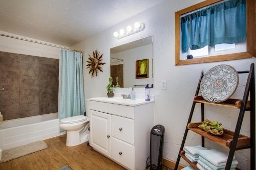 a bathroom with a sink and a toilet and a mirror at Starfire Relaxation Retreat in Joshua Tree