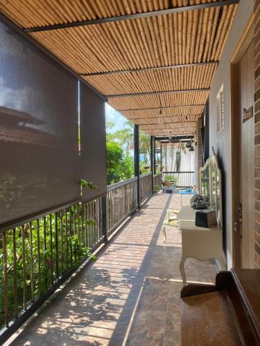 a balcony of a house with a wooden ceiling at Villa Juana Hotel in Pereira