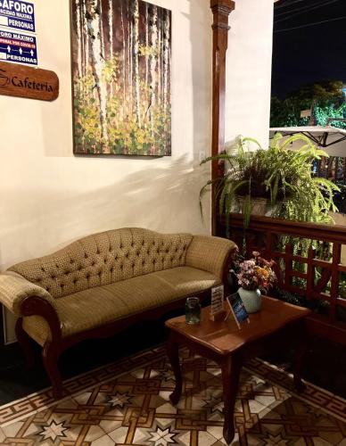 a living room with a couch and a table at Lima Wari Hotel Boutique in Lima