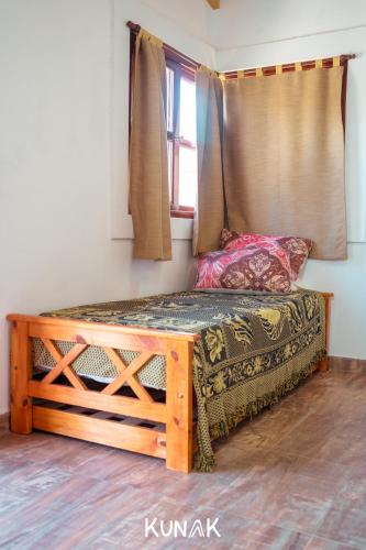 a bed in a room with a window at kunak in Yala