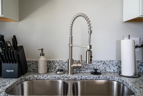 a kitchen sink with a faucet in a kitchen at Luxury 1 bed APT near Five Point. Pets welcome! in Columbia