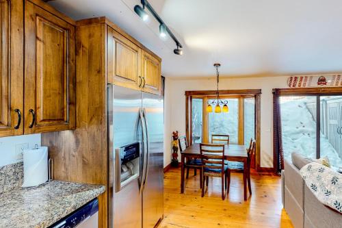 a kitchen and dining room with a refrigerator and a table at Ideal in Idaho in Ketchum
