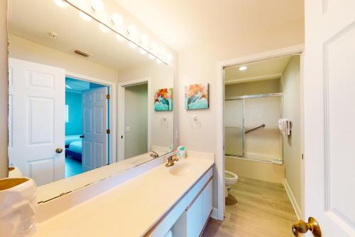a bathroom with a sink and a large mirror at Navarre Beach Regency 805 in Navarre