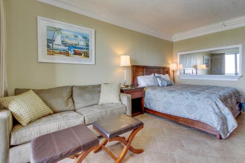 a hotel room with a bed and a couch at Pirates Bay A410 in Fort Walton Beach