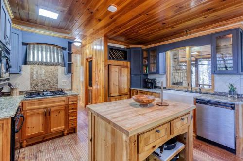 a kitchen with wooden cabinets and a wooden ceiling at Gorgeous 6BR Cabin w/Spa, Firepit, Arcade& Mountain View in Mineral Bluff