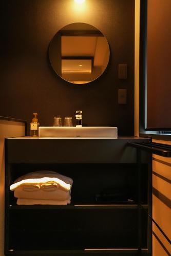 a bathroom counter with a sink and a mirror at N Plus Hotel Akihabara in Tokyo