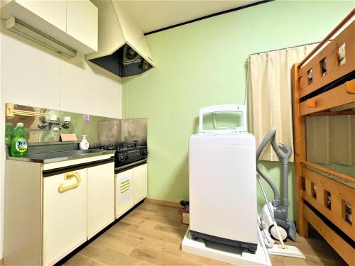 a small kitchen with a sink and a refrigerator at House Kadoi202 in Tokyo