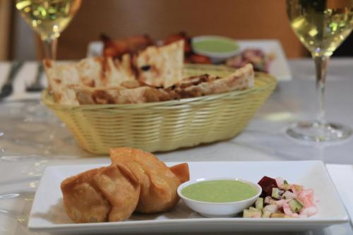 a plate of food on a table with a basket of food at Cootamundra Gardens Motel in Cootamundra