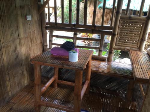 a table and two chairs on a porch at Coco Garden Villas in El Nido