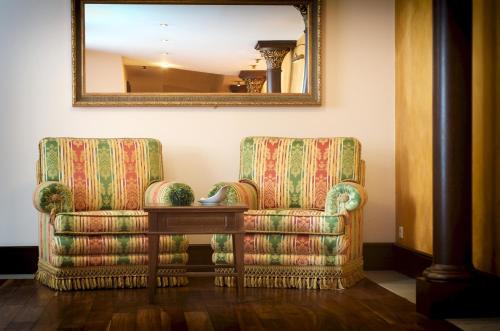 a living room with a chair and a table at Wellnesshotel Schönruh - Adults only in Seefeld in Tirol