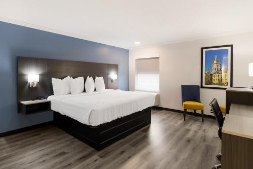 a hotel room with a large bed and a desk at Quality Inn South Bend near Notre Dame in South Bend