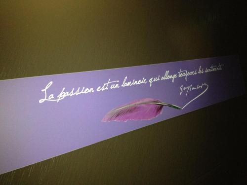 a purple card with a purple feather on it at Hôtel Elysées Flaubert in Paris