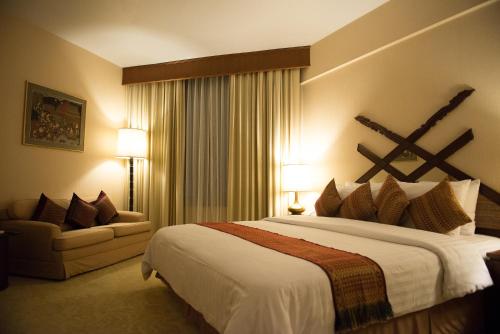 En eller flere senge i et værelse på Wiang Inn Hotel