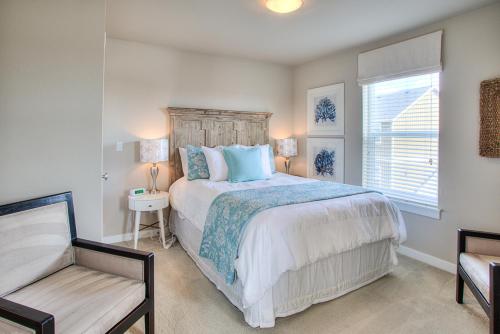 a bedroom with a bed and a chair and a window at Just Beachy in Ocean Shores