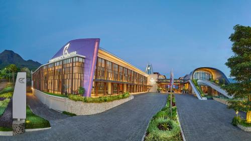 a large building with a road in front of it at Golden Tulip Holland Resort Batu in Batu